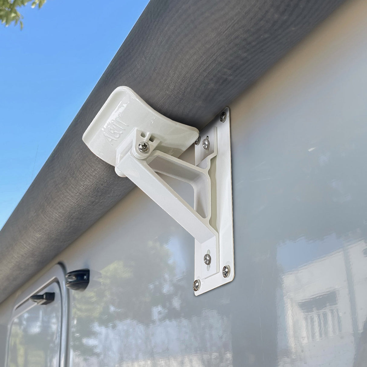Close-up of AWNLUX RV awning roller cradle support bracket securely mounted on camper side wall