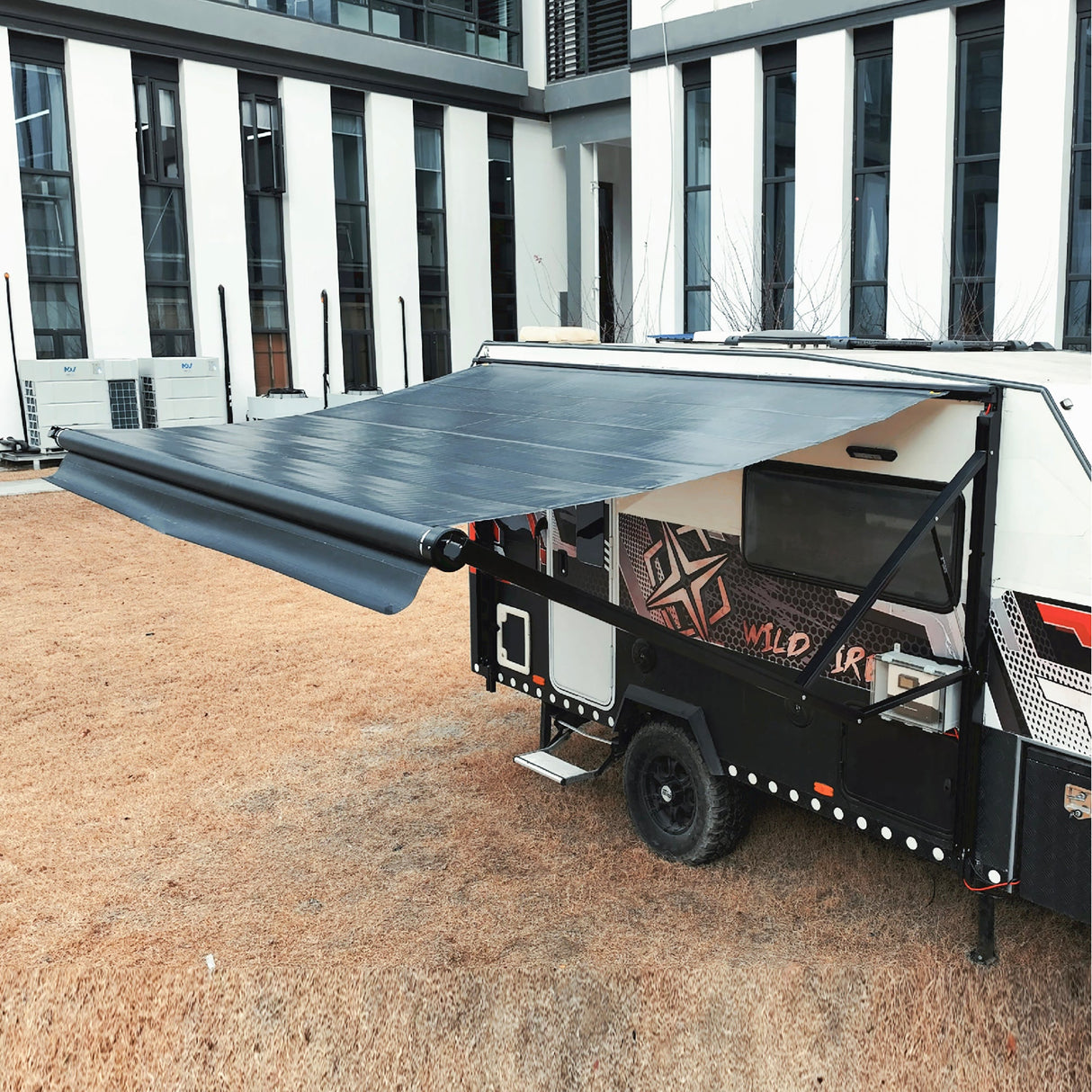 AWNLUX electric solar RV awning extended on camper, showing reinforced frame and weatherproof solar fabric