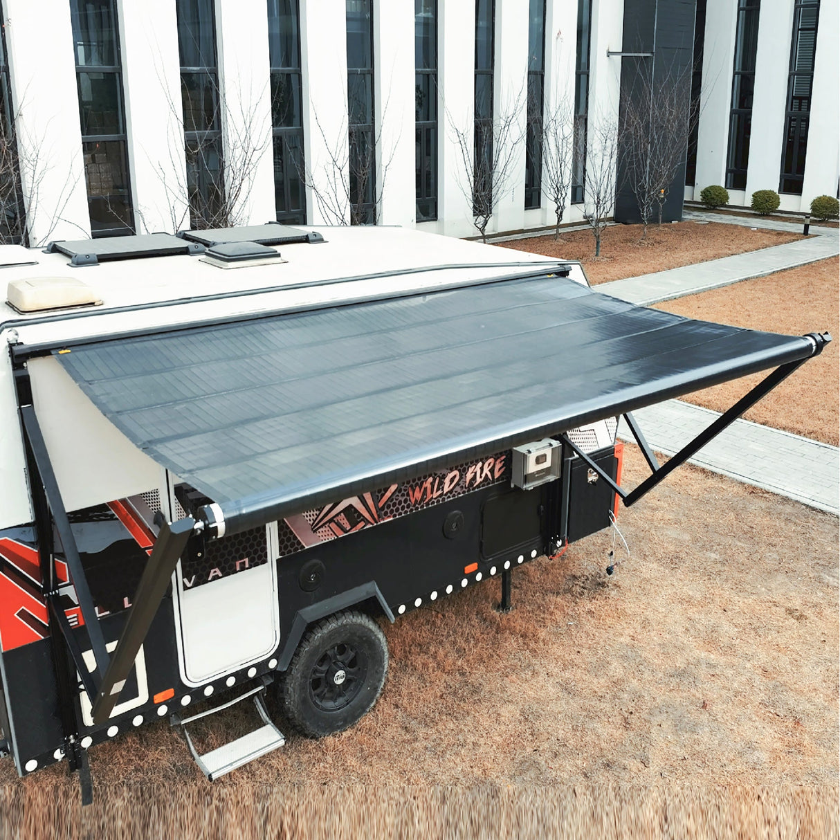 Camper trailer equipped with AWNLUX electric solar awning creating outdoor living space with full sun protection