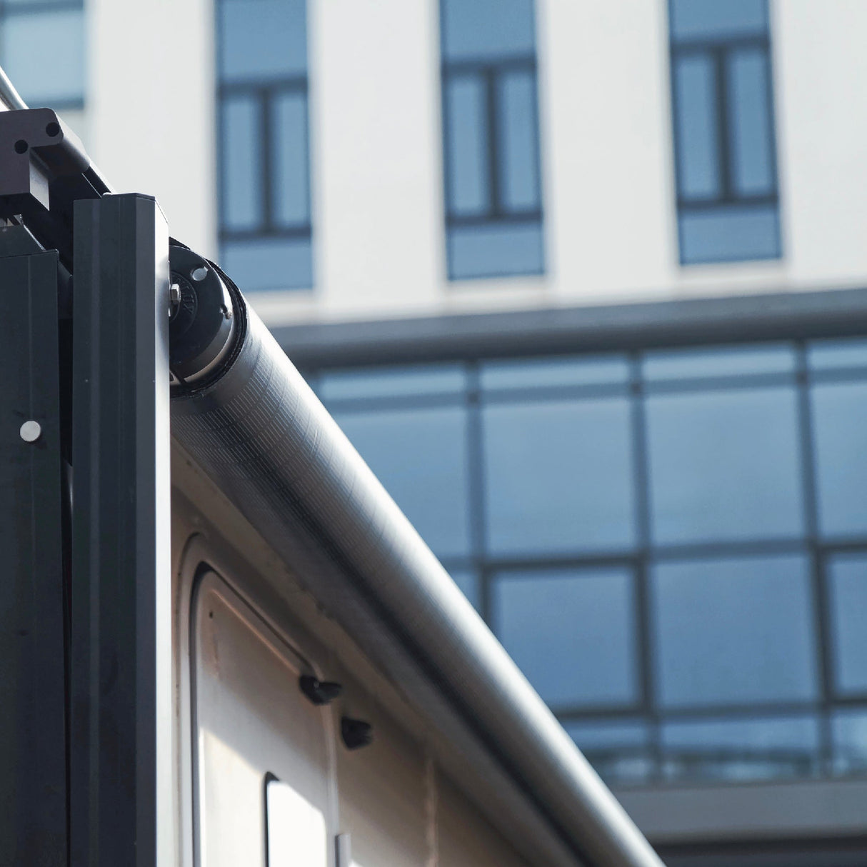 Close-up of AWNLUX solar RV awning roller tube in closed position, showing sleek design