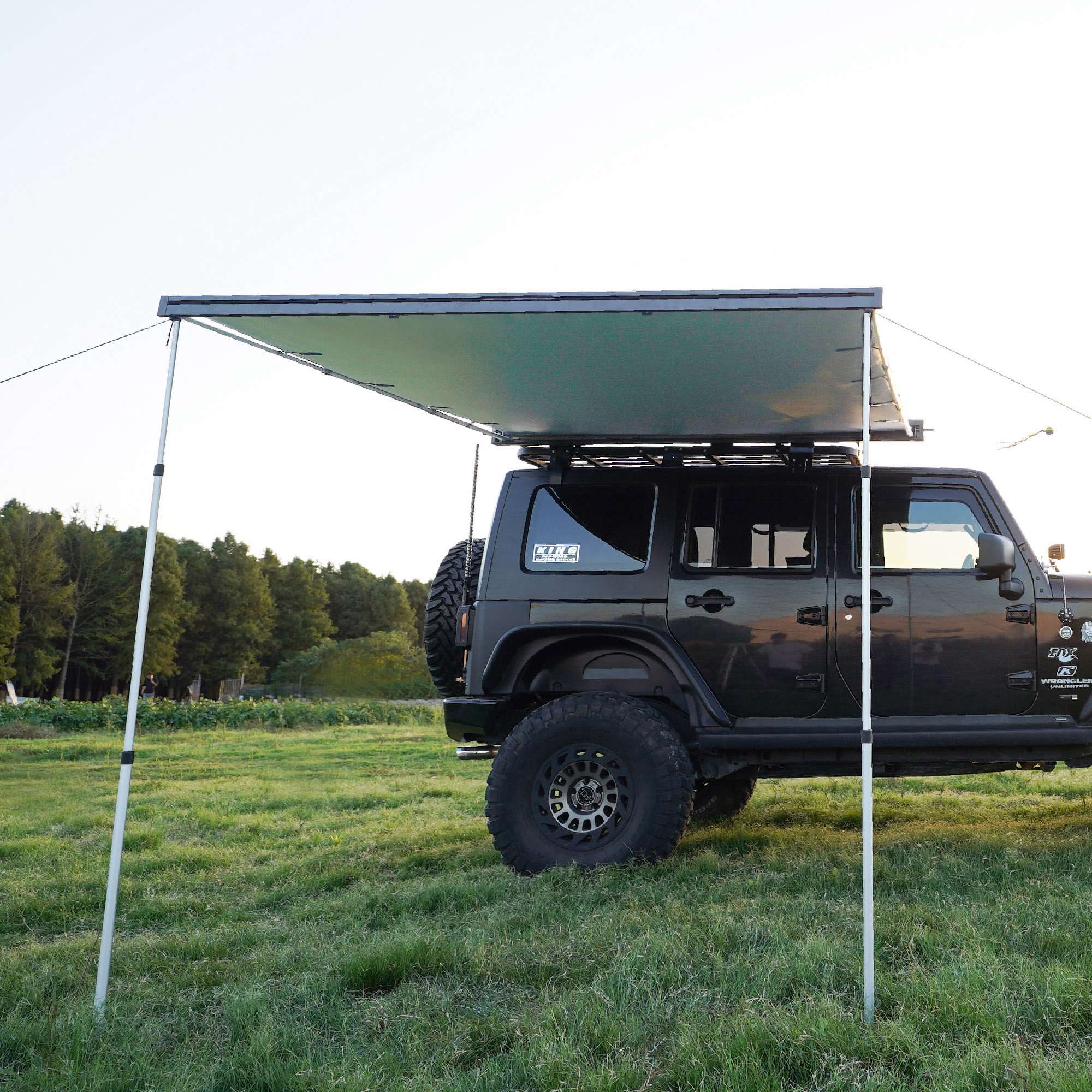AWNLUX 4x4 SUV awning deployed beside an off-road vehicle