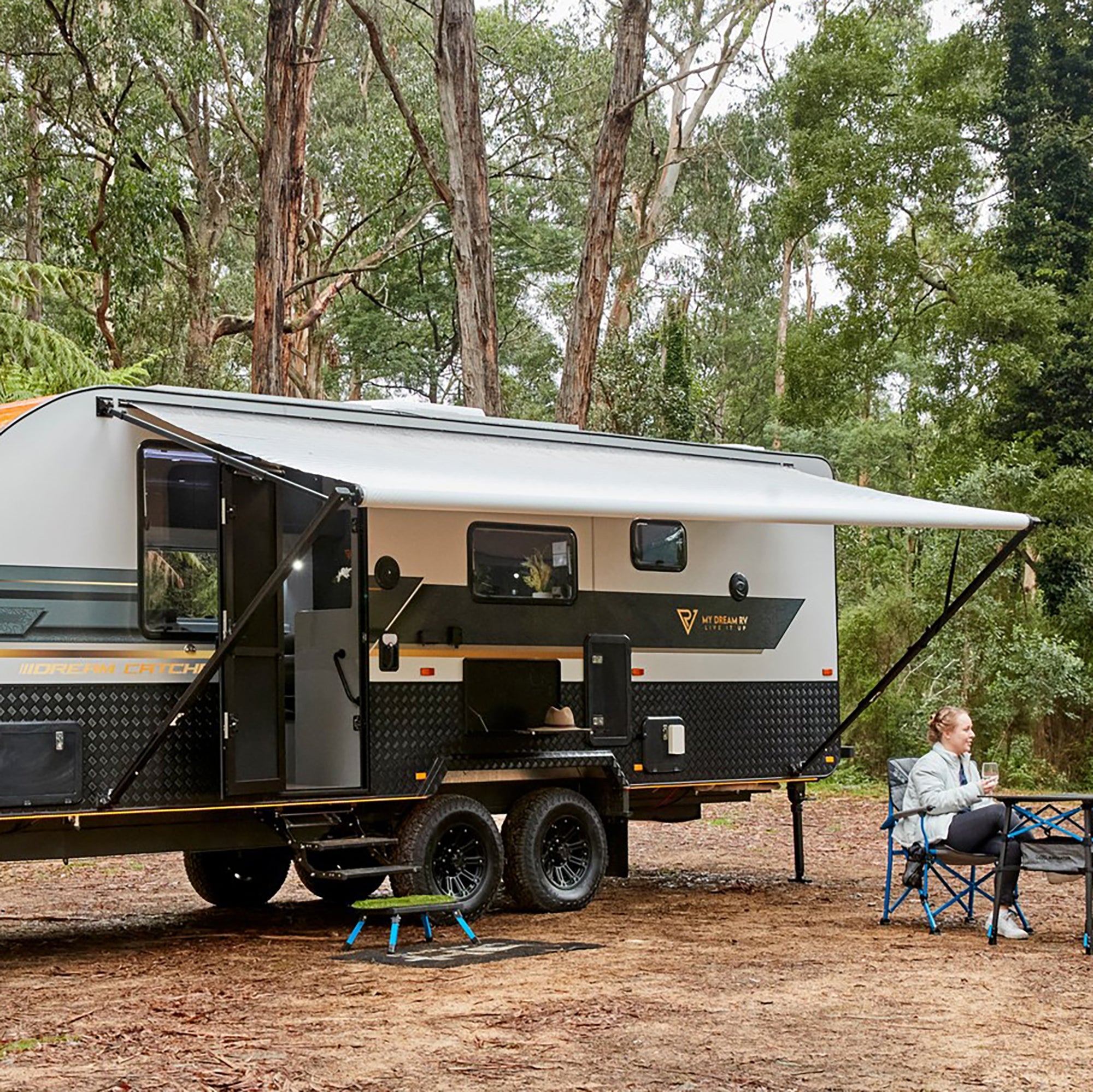 AWNLUX manual RV patio awning extended beside a recreational vehicle